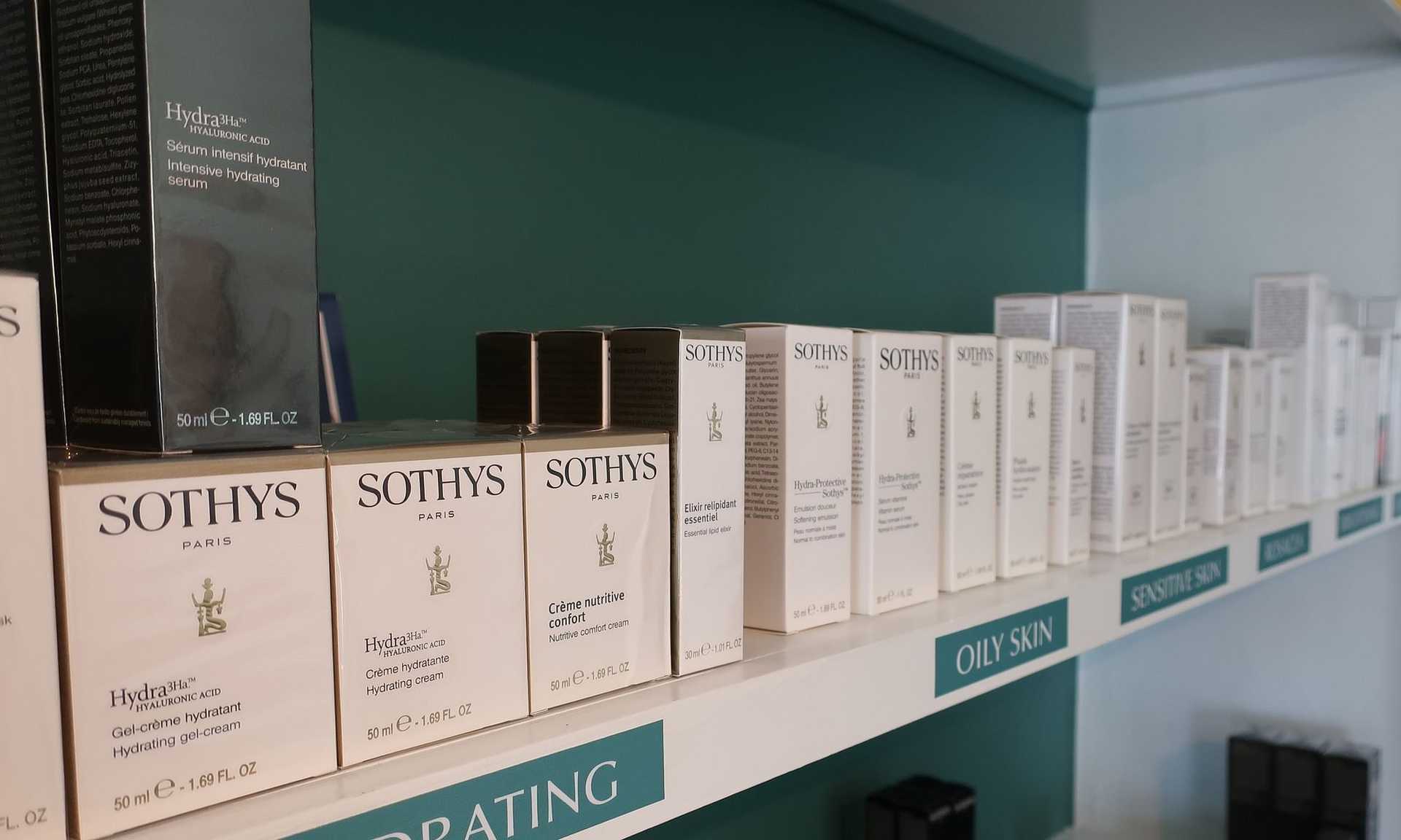 Shelf filled with various Sothys Paris skincare product boxes, including hydrating and oily skin lines.