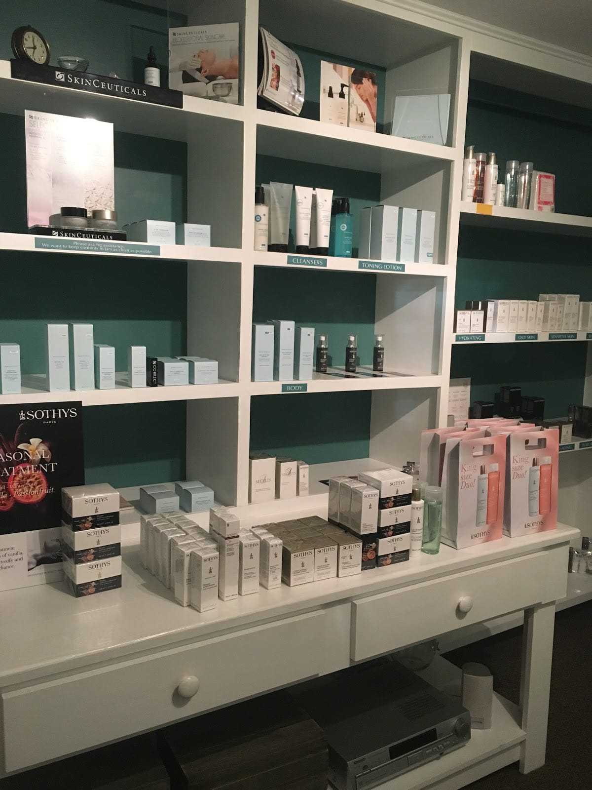 Shelves filled with skincare and beauty products in a store display.